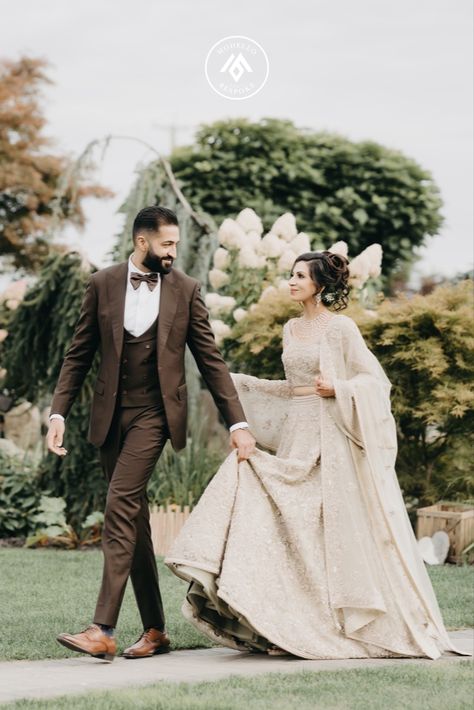 Groom in a three piece chocolate brown Modello suit with the bride complimenting in a beige lehenga. They're giving couple goals vibes 😍 Chocolate Brown Groom Suit, Wedding Suit Indian, Brown Three Piece Suit, Brown Groom Suit, Brown Wedding Suit, Chocolate Brown Wedding, Beige Lehenga, Suit Indian, Bespoke Suits