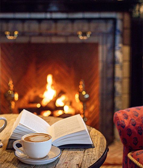 Winter Hotel Aesthetic, Fireplace Photoshoot, Fireplace Aesthetic, Winter Hotel, Fireplace Photography, Black Mantle, Hotel Christmas, Winter Fireplace, Outdoor Winter Wedding