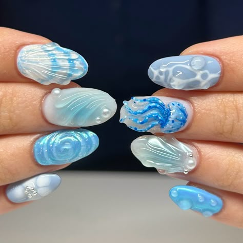 Short almond nails with an ocean theme. Includes a 3d hand sculpted jelly fish and blue chrome. Summer Nails Jellyfish, 3d Ocean Nails, Water Looking Nails, Nail Ocean Designs, Shark Nails Art, Oceancore Nails, Sting Ray Nails, Under Water Nails, Cute Ocean Nails