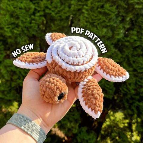 Crochet a no-sew amigurumi cinnamon roll turtle with this PDF pattern. In this pattern I include step by step instructions, photos and links to video tutorials to set you up for success when creating a plushie with one of my patterns. This is not a finished plushie, but a pattern for you to make your own plush. This product is best suited for someone who knows how to read patterns and has a basic understanding of amigurumi style crochet English Pattern, US Crochet Terminology  Finished Plushie f Banana Split Crochet, New Sew Crochet Amigurumi Free Patterns, Food Animals Crochet, Quick And Easy Crochet Amigurumi, No Sew Crochet Projects, Food Turtle Crochet, Crochet Patterns No Sew, How To Make Plushies, Free Crochet Patterns No Sew