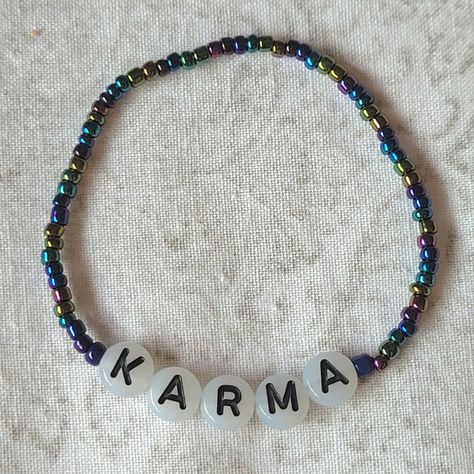 Friendship bracelet with the word Karma in glow in the dark letters, very small seed beads are around it in metalic colours Glow In The Dark Friendship Bracelet, Dark Friendship Bracelets, Karma Friendship Bracelet, Karma Taylor Swift, Swiftie Bracelets, Swift Bracelet, Swift Bracelets, Metal Bead Bracelet, Era Tour