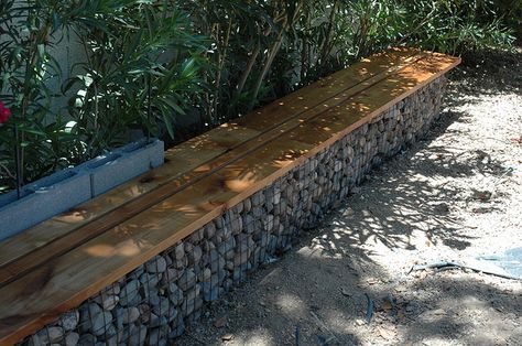 gabion benches gabion cages topped with wood seat.. Gabion cages carried around tree along fence to provide bench for seating Gabion Walls, Gabion Stone, Gabion Retaining Wall, Ideas Terraza, Keyhole Garden, Stone Wall Design, Gabion Wall, Sloped Garden, Walled Garden