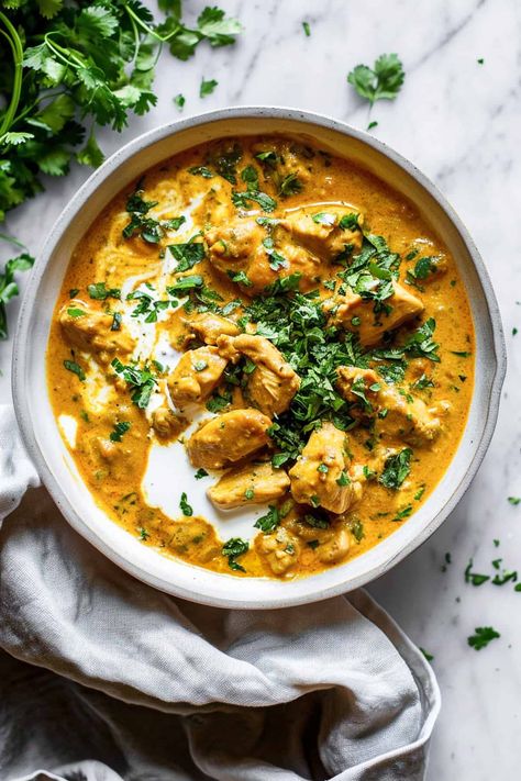 A slow cooker chicken korma is a creamy and mild curry that uses simple pantry ingredients that are available in Aldi, or any other grocery store. Seared golden chicken, slow-cooked in a tangy and fragrant coconut milk yoghurt sauce, this is going to be a family favourite that everyone will love. It's also perfect for freezing so makes a great addition to meal planning. Aldi recipes, dinner, budget recipes. Mild Coconut Curry Chicken, Interesting Crockpot Recipes, Coconut Chicken Korma Recipe, Coconut Chicken Slow Cooker, Chicken Coconut Korma, Slow Cooker Yellow Chicken Curry, Ministry Of Curry Recipes, Healthy Indian Curry Recipes, Crockpot Chicken Korma