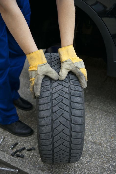 Change of tyres. An auto mechanic and changing tires #Sponsored , #SPONSORED, #paid, #tyres, #tires, #changing, #Change Spare Tires, Auto Mechanic, Tire Change, Car Mechanic, Hand Holding, Spare Tire, Infographic Design, Tires, Stock Images