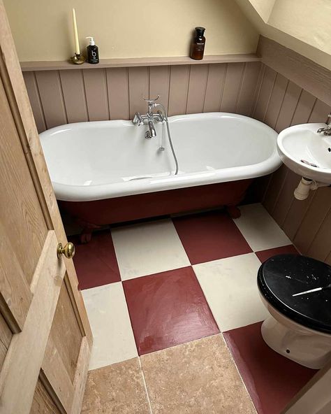 Checkboard pattern being painted on tile flooring. Diy Checkerboard, Cottagecore Bathroom, Cozy Cottagecore, Colorful Cottage, Painting Tile Floors, Dark Tile, Checkerboard Floor, Bathroom Red, Soaker Tub