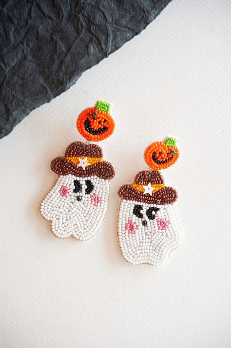 Saddle up for Halloween with our Cowboy Ghost Dangle Earrings, where whimsy meets the Wild West. Each earring features a playful combination of a beaded ghost and pumpkin, capturing the spirit of the season with a touch of cowboy charm. Perfect for adding a unique twist to your Halloween attire, whether you're wrangling candy or two-stepping at a spooky soirée. Embrace the frontier of festive fun with these earrings that blend playful design with a hint of Halloween mystery. Beaded Ghost, Halloween Beading, Beaded Halloween, Cowboy Ghost, Halloween Mystery, Seed Bead Crafts, Pumpkin Bead, Halloween Beads, Pumpkin Earrings