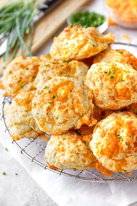 These warm and fluffy drop biscuits made with buttermilk are brimming with the flavor of sharp cheddar cheese and chives! | thecozyapron.com #dropbiscuits #dropbiscuitseasy #dropbiscuitseasyallpurposeflour #dropbiscuitsrecipe #dropbiscuitshomemade Olive Oil Drop Biscuits, Sausage Drop Biscuits, Drop Buiscits Recipes, Drop Biscuits Recipe, Hand Pies Savory, Cream Biscuits, Homemade Cornbread, Sausage Balls, Drop Biscuits