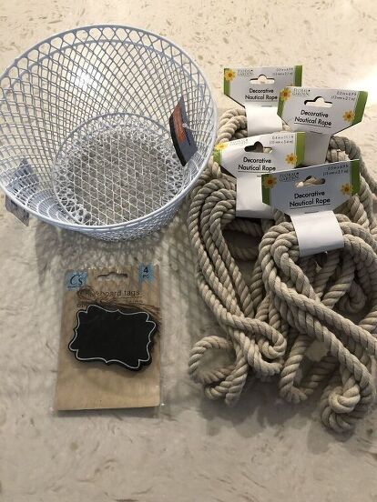 I think I have become addicted to Dollar Tree DIY’s. I was in my local Dollar Tree store recently and found some nautical rope. It’s nice quality, so naturally I grabbed 5 of them! Then I was like, hmmmm……ok, what the heck am I going to do with this. As I continued walking around the store, I found some small wire baskets, and some mini chalkboard signs, and the idea to try my hand at making a DIY Dollar Tree Rope Basket came into my head. Here is how I did it…   Here are the supplies… Rope Storage Basket Diy, Diy Kitchen Utensil Holder, Diy Declutter, Mini Chalkboard Signs, Dollar Tree Baskets, Tree Rope, Diy Rope Basket, Mini Chalkboards, Basket Crafts