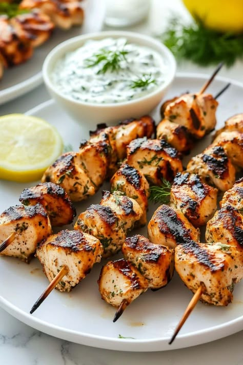 Greek chicken souvlaki with tzatziki brings the vibrant flavors of the Mediterranean right to your table. It's savory, zesty, and oh-so-juicy. Greek Wraps Chicken Tzatziki Sauce, Greek Dishes Traditional Chicken, Greek Chicken Spices, Greek Kabobs Chicken, Greek Chicken Kebab Recipe, Greek Meal Ideas, Souvlaki Chicken Marinade, Chicken Tzatziki Recipes, Greek Wedding Food