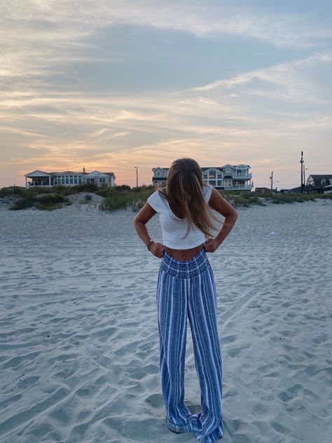 sunset pictures, sunset pics, beach, sand, ocean, the shore, outfit inspo, sunset outfit inspo, date inspo, beach aesthetic, flowy pants, long pants, blue aesthetic, striped pants, summer pants, crop tops, white tops, family pictures, golden hour, teenage summers, instagram pictures, vsco aesthetic Blue Beach Pants Outfit, Blue Flowy Pants Outfit, Shore Outfit, Flowy Pants Outfit, Date Inspo, Beachy Pants, Sunset Outfit, Hawaii Outfits, Sunset Pics