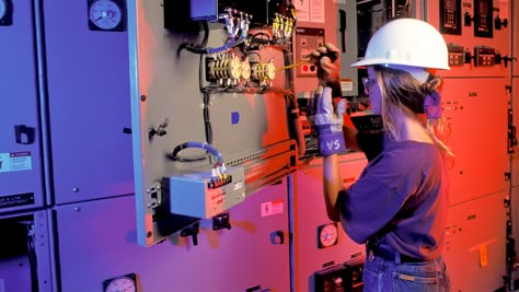 A female electrician works on electrical mains with a screwdriver Female Electrician Aesthetic, Female Electrical Engineer, Electrician Aesthetic, Women Electrician, Female Electrician, Women Engineer, Woman In Tech, Electric Engineering, Electricity Art