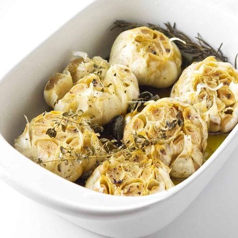 Oven Roasted GarlicOven Roasted Garlic is an easy and delicious way to add flavor to your food. This recipe for garlic roasted in oil is simple to follow, and the end result is a tasty addition to many other dishes. Imagine it added to salad dressings, mashed potatoes, or even on it's on on a charcuterie tray! Whether you're looking for a new condiment to put on your sandwiches or want something different for your pasta dish, this Oven Roasted Garlic Cloves In Olive Oil, Roasted Garlic Infused Olive Oil, Roasted Garlic Cloves For Bread, Roast Garlic Cloves, Roast Whole Garlic, Oven Roasted Garlic, Meat Cheese Platters, Roasting Garlic In Oven, Garlic Bulbs