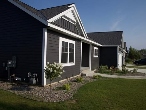 Dark Gray Siding With White Trim | Exterior Color Selections Dark Grey Vinyl Siding, Dark Grey House Exterior, Grey House White Trim, Vertical Siding Exterior, Dark Grey Siding, Dark Grey Houses, Grey Exterior House Colors, Spec House, House Renos