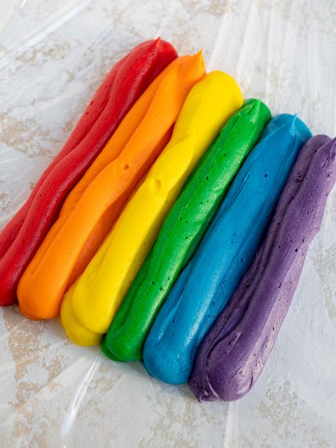 These rainbow frosting cupcakes are just as delicious as they are beautiful! They're made w/ tender funfetti cupcakes & buttercream frosting. Rainbow Buttercream Frosting, Rainbow Frosting Cupcakes, Pastry Pride Frosting Whipped Cream, Cupcakes With Rainbow Frosting, Multicolored Frosting Piping, Rainbow Frosted Cake, Rainbow Frosted Cupcakes, Rainbow Frosting, Funfetti Cupcakes