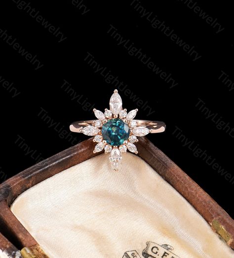 RING DESCRIPTION ✦Engagement Ring ✴Center Stone Round Cut - Teal Sapphire / Blue Moonstone / DEF Moissanite / Sunstone Size - 6mm ✴Side Stones Round Cut & Marquise Cut - Moissanite / Diamond Carat - approx 0.46 ct ✴Band Width - About 1.6mm ✴Ring Metal: Available in 14k/18k solid rose, yellow or white gold. ✦Find More Unique Art deco Rings： https://www.etsy.com/shop/TinyLightJewelry?section_id=36513259 CUSTOM SERVICE Our rings are customizable, including Special Ring Size Custom, CAD service, Gem Green Gem Stone Engagement Rings, Vintage Green Sapphire Ring, Peacock Sapphire Ring, Art Deco Engagement Ring Sapphire, Vintage Sapphire Engagement Rings, Teal Engagement Ring, Peacock Sapphire Engagement Ring, Sapphire Engagement Ring Round, Round Sapphire Engagement Ring