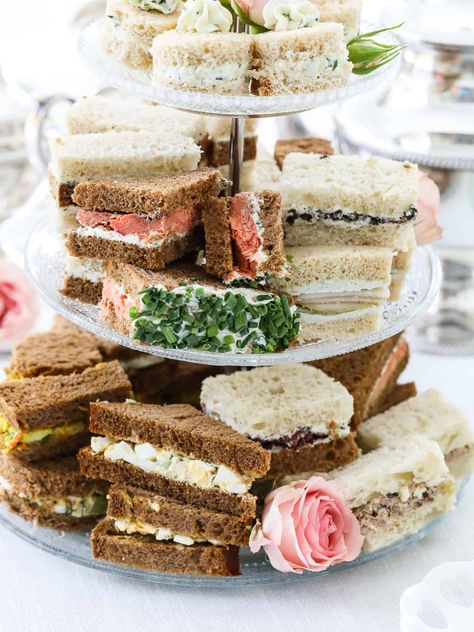 Elegant, dainty, crustless tea sandwiches are quintessential pinkies-up party food for a beautiful light lunch garden party, a bridal shower, or a Mother’s Day brunch. We cover everything from bread choices to filling options, the best ways to make tea sandwiches ahead, and how to create incredible savory flavors. Choose from over two dozen creative small bites from classic cucumber tea sandwiches from Buckingham Palace fit for a Queen, egg salad sandwiches, easy ham salad, and so much more. Mille Cake, Fall Baby Shower Food Ideas, Fall Baby Shower Food, Roast Beef And Cheddar, Cucumber Tea, Baby Shower Food Ideas, Shower Food Ideas, Smoked Salmon Sandwich, Wedding Foods