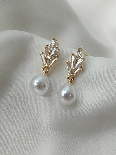 PRE ORDER FOR END JUNE DELIVERY A simple and elegant Art Deco inspired pearl drop earring for the Bride. A dainty teardrop pearl suspended from a fixed 18ct gold plated crystal stud earring. A simple elegant choice to treasure and wear time and time again. Materials 18ct gold plated earring for pierced ears Size Approx 2.8 cm in length x approx .6cm in width. Lightweight