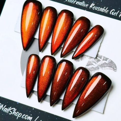 How perfect are these nails for Spooky Season!! 🎃 ☑️ @wayward__spirit (🖤) wanted a set of Betrothed.. but Burnt Orange 🥵, on Kiara Sky Long Stiletto 💅🏻 .⁣ .⁣ .⁣ .⁣ .⁣ #gothicnails #fallnails #ombrenails #halloweennailart #halloweennails #halloweennailsdesign #longnails #nailaddict #nailartist #naildesign #nailitdaily #spookynails #spookyseason #cateyenails #velvetcateye November Stiletto Nails, Pumpkin Stilleto Nails, Orange Stilleto Nail Ideas, Red Halloween Stilleto Nails, Orange Pointy Nails, Burnt Orange Stiletto Nails, Gothic Nails, Gel Press, Cat Eye Nails