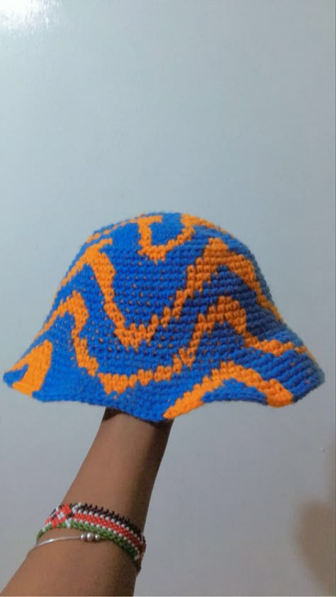 Blue and orange crochet bucket hat Colorful Crochet Bucket Hat, Crochet Bucket Hat Designs, Yellow Crochet Bucket Hat, Bucket Hat Knitted, Blue Crochet Bucket Hat, Crochet Patterns Bucket Hat, Orange Crochet Outfit, Knit Bucket Hat Pattern Free, Crochet Hat Bucket