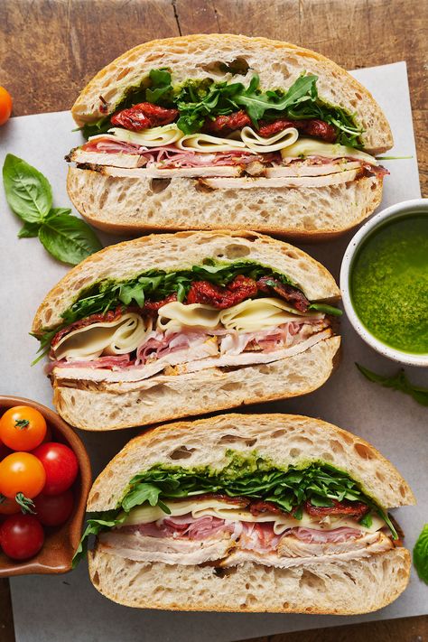 This crowd-pleasing Italian Turkey Club Sandwich is perfect for picnics, parties, or those nights it's just too hot to cook! Loaded with sliced turkey, prosciutto, arugula, sun-dried tomatoes, and a homemade Italian dressing, this recipe is so flavorful and fresh. So without further ado, let's make sandwiches! Turkey Club Sandwich, Club Sandwiches, Stomach Rumbling, Too Hot To Cook, Turkey Sandwiches Recipes, Sandwhich Recipes, Turkey Club, Empanada Recipe, Homemade Italian Dressing