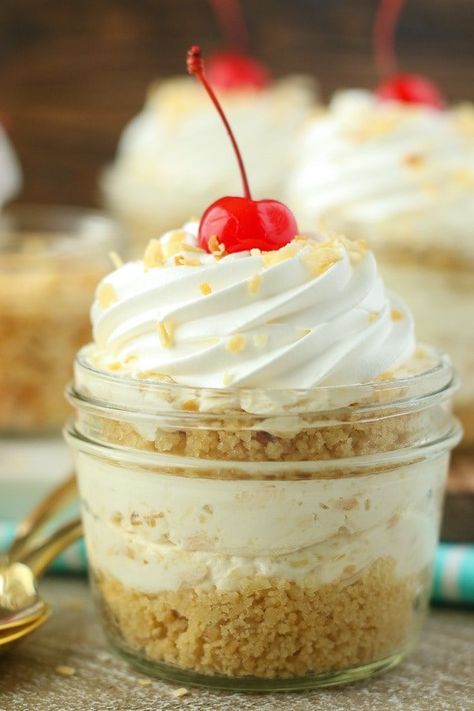 No-Bake Piña Colada Cheesecake Parfaits Pineapple Coconut Cheesecake, Pina Colada Cheesecake, Mason Jar Desserts Recipes, Layered Cheesecake, Pina Colada Cake, Cookies And Cream Cheesecake, Mason Jar Desserts, Cheesecake Parfaits, Dessert Shooters