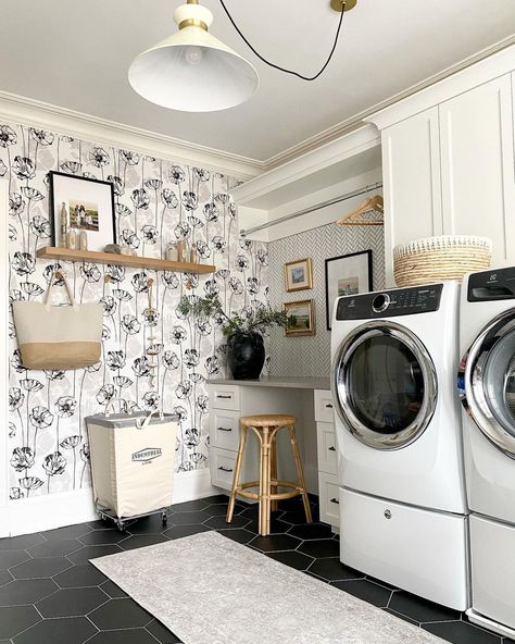 Floating wood shelf is mounted on white laundry room wallpaper with black and gray flowers. A gray runner rug covering black hexagon floor tiles is laid in front of a white washer and dryer on pedestals. Laundry Room Inspo, White Laundry Rooms, Laundry Room Wallpaper, Apple Iphone Wallpaper, White Laundry, Dream Laundry Room, Modern Laundry, Pantry Laundry, Wallpaper Room