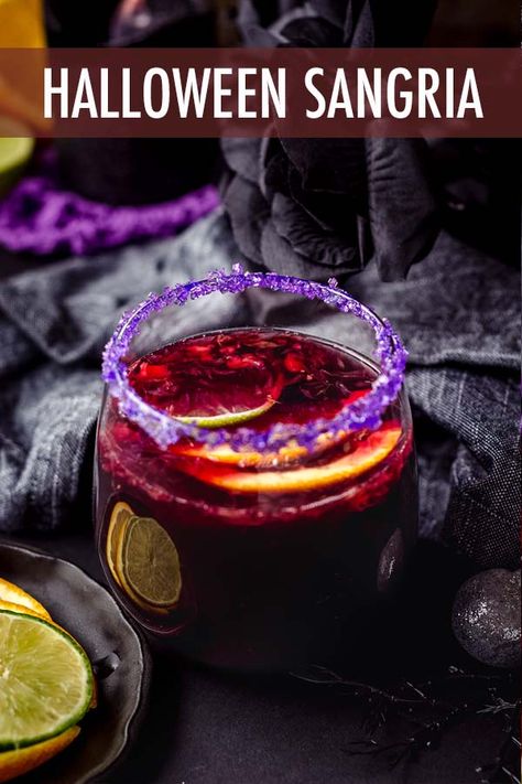 This spooky Halloween sangria is made with seasonal fruit, garnished with a colorful sugar rim, and is the perfect addition to your Halloween party spread. via @frshaprilflours Halloween Sangria Recipes, Halloween Drinks For Adults, Sangria Recipes Easy, Halloween Sangria, Halloween Drink Recipes, Halloween Cheesecake, Blackberry Sangria, Halloween Recipes Drinks, Easy Sangria Recipes