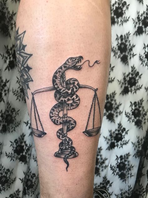 Scales of justice tattoo with a snake around it. Leg tattoo  Snake and scale tattoo Traditional Scale Tattoo Design, Weight Scale Tattoo, Leg Tattoo Snake, Scale Tattoo Men, Justice Scales Tattoo, Scales Of Justice Tattoo, Scales Tattoo, Law Tattoo, Justice Tattoo