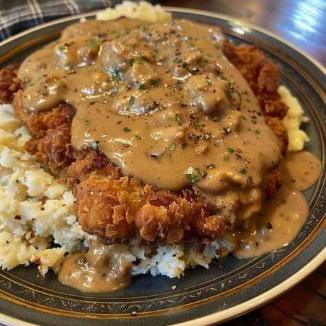 🥩🍴 Dive into the comfort of Chicken Fried Steak with creamy gravy! A true Southern delight. #ComfortFood #ChickenFriedSteak Chicken Fried Steak with Gravy Recipe Savor the crispy coating and tender steak, smothered in a rich, creamy gravy for a classic Southern meal. Ingredients: Beef cube steaks: 4 (about 600g total) All-purpose flour: 150g Eggs, beaten: 2 Milk: 120ml for batter + 240ml for gravy Salt: 5g Ground black pepper: 5g Garlic powder: 5g Vegetable oil for frying Butter: 30g Chic... Chicken Fried Steak And Eggs, Brown Gravy Chicken, Country Fried Chicken And Gravy, Steak With Gravy, Cube Steaks, Steak And Gravy, Fried Steak Recipes, Southern Dinner, Tender Steak