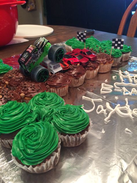 1st birthday monster truck cupcakes. Vanilla and chocolate cupcakes in shape of 1 Monster Truck Birthday Cake Cupcakes, Monster Jam Cupcake Cake, Cupcake Monster Truck, Monster Jam Cupcakes Ideas, Monster Jam Birthday Cupcakes, Monster Truck Pull Apart Cupcakes, Girls Monster Truck Birthday Party, Monster Truck Birthday Cupcakes, Monster Truck Cupcakes Ideas