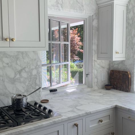 Marble slab backsplash, countertops framing window Countertop Backsplash Around Window, Marble Window Frame, Full Marble Backsplash, Kitchen Slab Backsplash, Quartz Backsplash Around Kitchen Window, Marble Slab Backsplash, Kitchen Window Backsplash, Slab Backsplash, Kitchen Quartz Backsplash