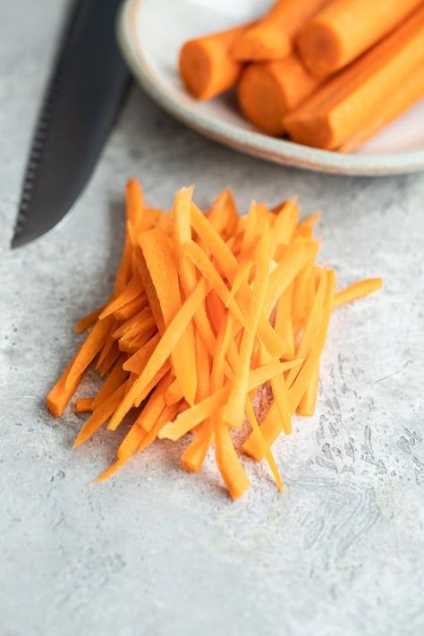 When salads, stir-fries, and other vegetable recipes call for julienned carrots, here’s what to do. Learning how to julienne carrots is definitely easier than it looks, and everyone will be seriously impressed with your professional knife skills. #carrots #juliennecarrots How To Julienne Carrots, Julienne Carrots, Crudite Platter, Vegetable Sticks, Food Shots, Julienned Carrots, Knife Skills, Quick Stir Fry, Copycat Restaurant Recipes