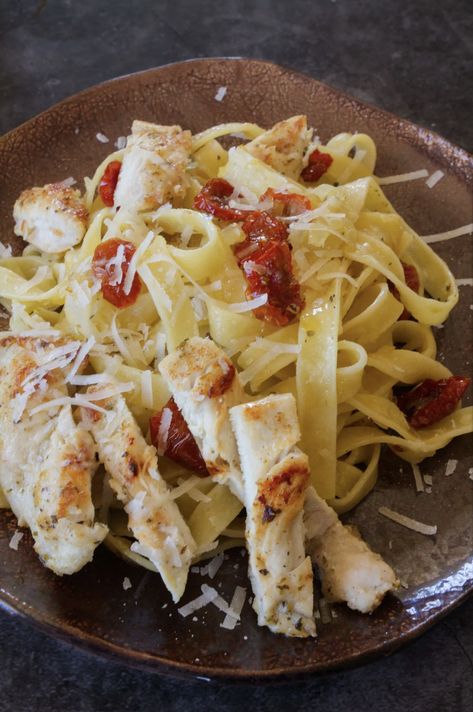 A beautiful brown serving dish with cooked tagliatelle pasta on it and chicken and sun-dried tomatoes Chicken Tagliatelle, Italian Pasta Recipe, Classic Italian Pasta, Sundried Tomato Pasta, Tagliatelle Pasta, Pan Fried Chicken, Chicken Slices, Italian Pasta Recipes, Drying Pasta