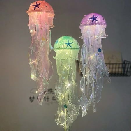 Description: By creating a soothing and relaxing environment, this night light will help you and your child fall asleep. You can use this Jellyfish decor light to light up your home and create a romantic ambiance, and this light is an ideal eye catching to your home or party decoration and makes the simple life more colors and interesting. It is made of high-quality acrylic and yarn material. The length of this product is 50cm and width is 12cm. It is widely used in bar, club, restaurant, park, Ocean Night Light, Hanging Ceiling Lights Bedroom, Ocean Aesthetic Decorations, Ceiling Light Aesthetic, Under The Sea Room Decor, Soft Light Aesthetic, Cute Fairy Lights, Jellyfish Lights, Mermaid Themed Bedroom