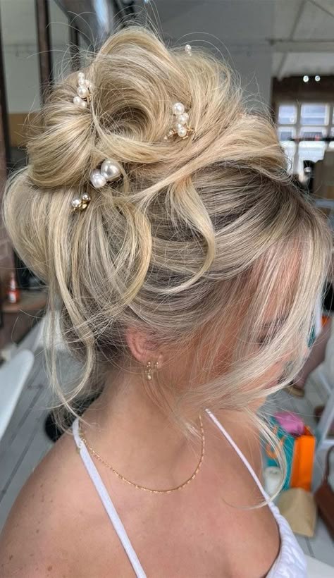 50+ Updo Hairstyles That're So Stylish : Blonde Messy High Bun High Updo Wedding Front View, Prom Hair Updo Elegant Classy, Updo Hairstyles With Crown, Blond Updo Hairstyles, Wedding Updo With Pearls, Wedding Hair Messy Bun, Prom Hairstyles For Long Hair Updo, Formal Up Do, Glam Bridal Hair Updo