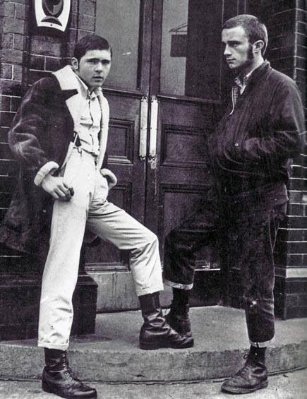 There was a funny period in the late 1960s as hard mods evolved into something else. This picture shows an early skinhead alongside a suede head. The latter were short lived. They shared the skins’ love of DMs and casual mod fashions, but retained modernist hair styles and developed a fondness for sheepskin jackets. Skinhead Fashion, Youth Subcultures, Tokyo Street Fashion, Teddy Boys, Rude Boy, Punk Rocker, Youth Culture, Working Class