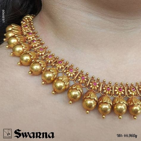 Very unique blooming golden bud Antique necklace with tiny ruby studded flowers on top.. ending with a goddess Lakshmi moop.. Shop Online… Antique Necklaces Design, New Gold Jewellery Designs, Gold Earrings Models, Indian Bridal Jewelry Sets, Gold Jewelry Simple Necklace, Jewelry Set Design, Gold Bridal Jewellery Sets, Antique Bridal Jewelry, Gold Jewelry Stores