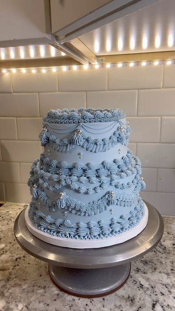 Tay on Instagram: "Glittery blue ✨ #buttercream #buttercreamcakes #buttercreamcake #cake #cakedecorating #cakedesign #wilton #wiltontips #wiltoncakes #austintx #austintexas #austin #texascakes#cakesofinstagram #austincakes#buttercreamdecorating #heartcake #pearlcake #birthdaycake #vintagecake #shellborder #rufflecake #ruffleborder #ediblepearls #y2kcake #shellborder #buttercreamdesign" Sweet 16 Winter Wonderland Theme Cake, Sweet Sixteen Cakes Blue, Ice Blue Birthday Cake, Blue And White Sweet 16 Cake, Light Blue Cake Ideas, Sweet 16 Cakes Blue And Silver, Sweet 16 Cake Ideas Blue, Light Blue Cake Aesthetic, Winter Wonderland Sweet 16 Cake