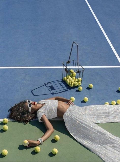 a girl laying on a tennis court with many balls and a basket surrounding her. she is wearing a white flowy set, but the clothes have been edited so they’re white glitter instead. Sports Fashion Photography, Vogue Fashion Photography, Fashion Photography Editorial Vogue, Tennis Court Photoshoot, Tennis Photoshoot, Lisa Haydon, Artistic Fashion Photography, Sport Fashion Photography, Viviane Sassen