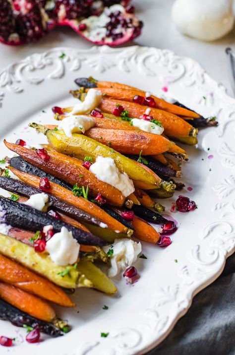 This quick and easy side dish looks so fancy but takes no work at all! These carrots are glazed with a honey cinnamon butter, roasted in the oven, and then garnished with fresh burrata cheese and pomegranate arils. This is a great side dish for Thanksgiving, Sunday dinner, Christmas or just as a fast dinner idea. Plus, everyone loves them! #carrots #sidedish #roasted #recipe #gourmet #honey #butter #pomegranate #autumn #winter #dinner #supper #homemade Menu Birthday Party, Rainbow Carrot Recipes, Honey Cinnamon Butter, Thanksgiving Sunday, Roasted Rainbow Carrots, Winter Dinner Party, Roasted Carrots Recipe, Honey Roasted Carrots, Dinner Christmas