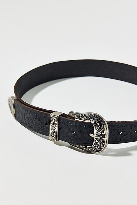 Stamped leather belt with classic western styling. Features Stamped Jennie western belt Stamped leather belt Classic western detailing Metal buckle and tipped end Adjustable fit Content + Care Leather, mixed metal Wipe clean Imported Size + Fit XS=32" S=34" M=38" L=42" XL=46" | Stamped Jennie Western Belt in Black, Women's at Urban Outfitters Womens Belts, Stamped Leather, Men's Shoes Accessories, Western Belt, Western Belts, Black Leather Belt, Women Men Shoes, Mixed Metals, Black Fits