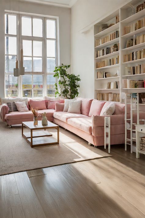 Bright Reading Corner • Well-lit room with tall, classic windows letting in the sunlight • Cozy pink sectional sofa, perfect for reading and relaxing • A simple yet stylish wooden coffee table complements the soft sofa tones • Natural fiber area rug adds warmth and texture to the light wood flooring • Full bookshelf suggests a literary haven for book lovers • Indoor green plant brings a touch of freshness to the cozy setup • The room offers a harmonious blend of comfort and simplicity Pink Scandinavian Living Room, Light Pink Couch, Pink Sectional Sofa, Pink Aesthetic Home, Pink Sectional, Pink Sofa Living Room, Full Bookshelf, Light Wood Flooring, Soft Pink Aesthetic