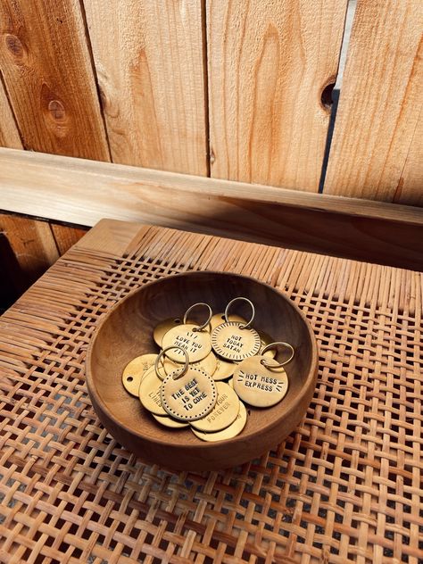 brass key tags hand-stamped with custom phrases in a wooden bowl Car Key Aesthetic, Key Aesthetic, Brass Keychain, Ventura California, Key Tags, Custom Tags, Handmade Brass, Wood Watch, Hand Stamped