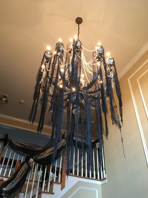 Halloween creepy cloth chandelier Halloween Decor Chandelier, How To Decorate Chandelier For Halloween, Halloween Venue Decorations, Halloween Ceiling Ideas, Chandelier Halloween Decor, Halloween Chandelier Diy, Creepy Cloth Decorations, Diy Halloween Chandelier, Halloween Chandelier Decor