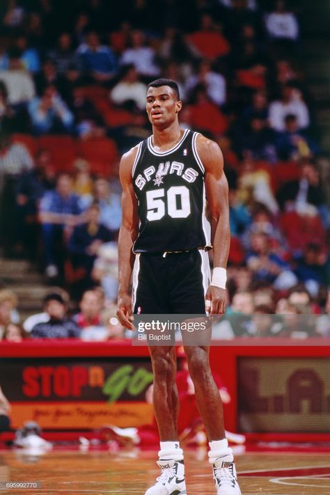 David Robinson #50 of the San Antonio Spurs stands on the court against the Houston Rockets during a game played circa 1990 at the Summit in Houston, Texas. Rose Nba, Spurs Basketball, Danny Green, Kobe Bryant Nba, Texas Sports, David Robinson, Action Images, Nba Fashion, School Basketball