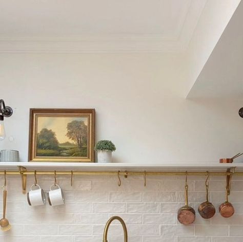 Perrin and Rowe on Instagram: "Whether your kitchen is small or spacious, open shelving offers a fresh and modern approach to storage, which combines aesthetics and functionality. Seen here in @little.leam.home, this beautifully serene kitchen incorporates open shelving and a utensil rail so essential tools are within arm's reach while also keeping worktops clutter free. Painted in @farrowandball Wimborne White, the kitchen includes our aged brass Ionian mixer and rinse along with our Parthia Open Shelving Brass Brackets, Kitchen Shelves With Brass Rail, Kitchen Shelf With Rail, Single Open Shelf Kitchen, Brass Rail Kitchen, Howden Kitchen, Kitchen Rail With Hooks, Kitchen Shelf Ideas, Serene Kitchen