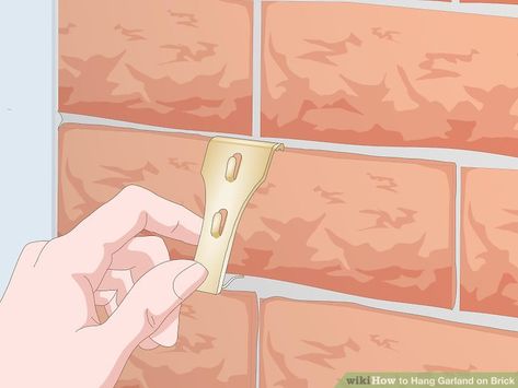 3 Simple Ways to Hang Garland on Brick - wikiHow How To Hang Garland On Brick House, How To Attach Garland To Brick, Hanging Garland On Brick, How To Hang Garland On Brick, How To Hang Garland Around Doorway, Brick Clips, Outdoor Garland, Hanging Flags, How To Make Garland