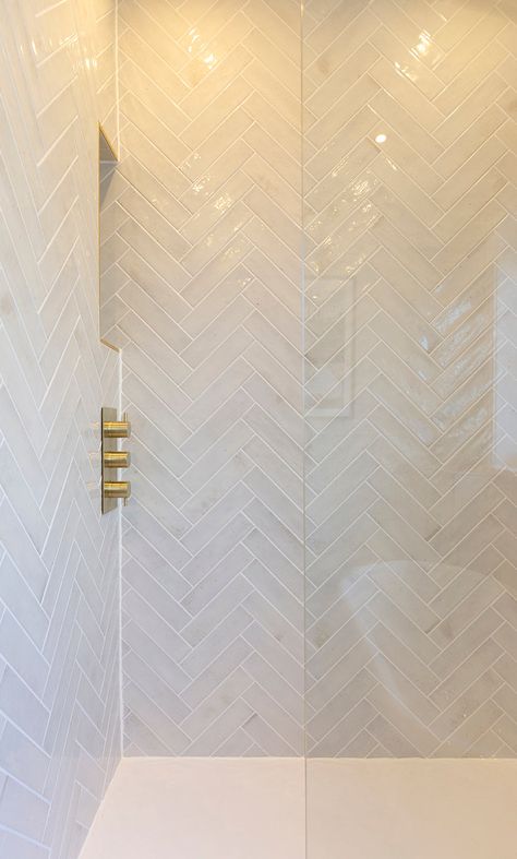 Nori Pearl Gloss Metro Tiles | Quorn Stone White Shower Room Ideas, Pearlised Tiles Bathroom, Marble Herringbone Shower Wall, Shiny Tile Bathroom, Shiny White Tile Bathroom, Family Bathroom Tile Ideas, Neutral Herringbone Tile Bathroom, Geometric Shower Tile, Fishbone Tiles Bathroom