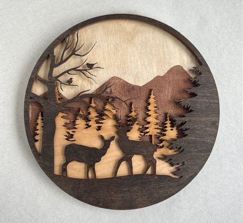 Laser engraved and cut layered forest deer scene. Available in 3 sides (10/16/22 inches). Made from layers of stained birchwood. Layered Wood Projects, Laser Engraving Ideas Projects, Router Ideas, Laser Creations, Layer Pictures, Deer Scene, Wooden Deer, Glowforge Ideas, Glowforge Projects