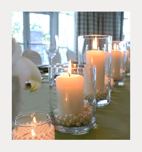 Elegant DIY Pearl and Candle Centerpieces Simple Candle Centerpieces Wedding Diy Table Decorations, Floating Pearls Centerpiece, Pearl Centerpiece Wedding, Rustic Bridal Shower Centerpieces, Bead Centerpieces, Candle Centerpieces Elegant, Wedding Centerpieces Elegant, Cheap Wedding Table Centerpieces, Catholic Candles